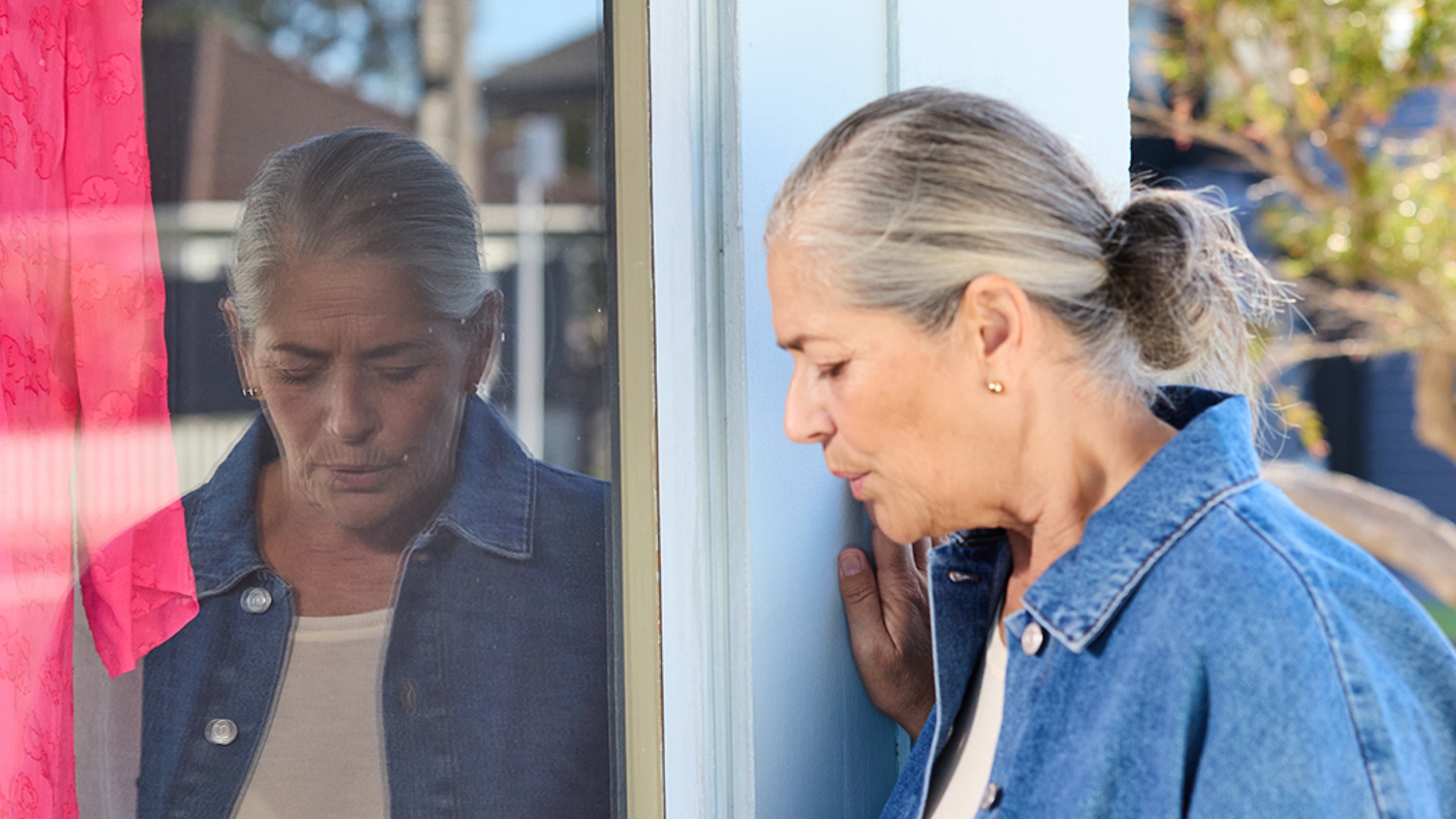 woman staring into window image